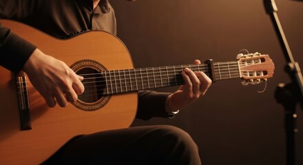 Obraz premium Close-up of hands expertly playing a classical acoustic guitar