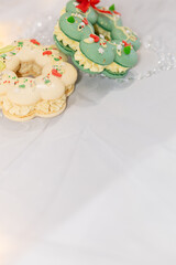 macaron dessert in shape of christmas wreath. homemade unique cookie. bow and sprinkles. white and green. isolated