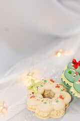 macaron dessert in shape of christmas wreath. homemade unique cookie. bow and sprinkles. white and green. isolated