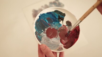 Closeup slow motion video of an abstract acrylic or oil painting in pastel pink and green colors. Creative process of an artist painting on canvas. State of flow and creativity. - Powered by Adobe