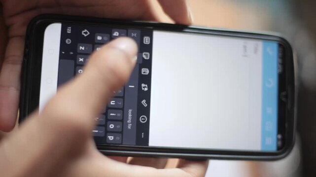Human hand holding smartphone and typing with thumb showing Generation X mobile behavior, steady texting motion, familiar keypad habit and natural digital communication in daily phone usage footage
