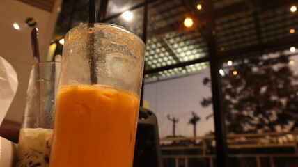 drinks on a table with a cafe in the background.