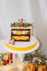 plate of different christmas desserts. macaron, profiteroles, cake. decorated cookie. bow and sprinkles. various colors. present box. wreath, tree, branch. white