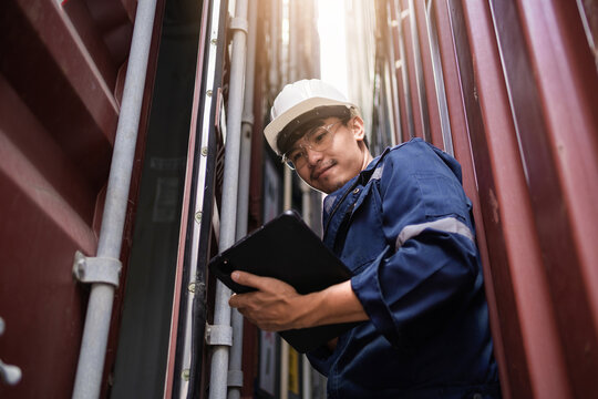 A man in a blue jacket is holding a tablet in his hand - Powered by Adobe