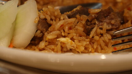 Enjoy fried rice with meat topping, a signature Indonesian food.