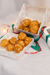 christmas sweet profiteroles. decorated in gift box. tasty dessert. white background
