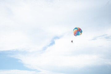 Batu Ferringhi Parasailing Experience in flight at the beach with sky in the background