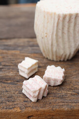Fresh sliced taro root on wood background