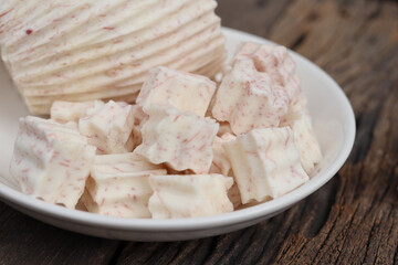 Fresh sliced taro root on wood background