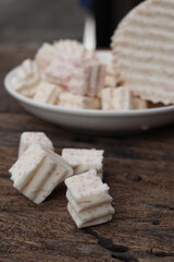 Fresh sliced taro root on wood background