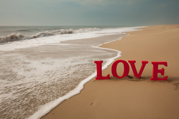 Red "LOVE" Word Sign on a Serene Sandy Beach with Ocean Waves - Romance and Valentine's Day Concept