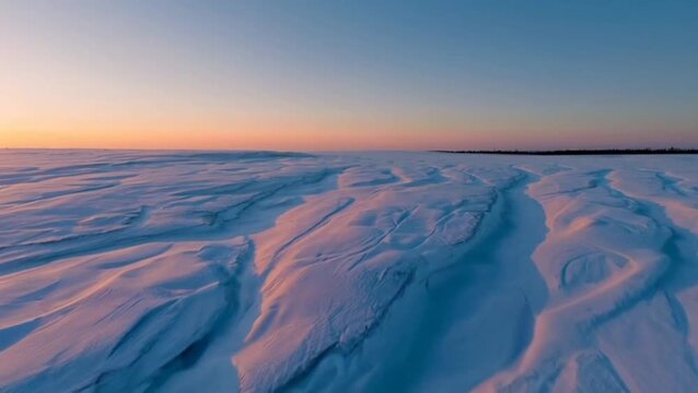  Wide panoramic of snowfields glowing orange at dawn.
