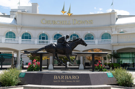 Vertical photo of the Grand Entrance to the Kentucky Derby at Churchill Downs in Louisville Kentucky.  Shown is a sculpture of the thoroughbred, Barbaro.