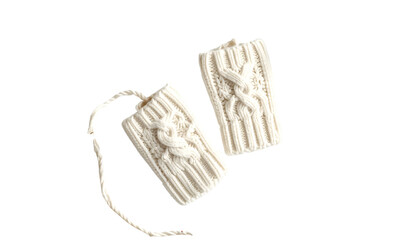 Two knitted white fingerless gloves on black, tied together