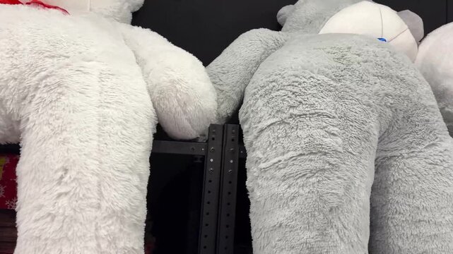 large stuffed teddy bears displayed on store shelv