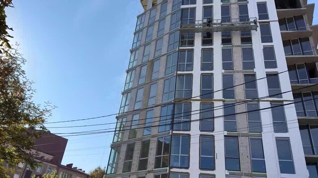 construction workers on a suspended platform insta