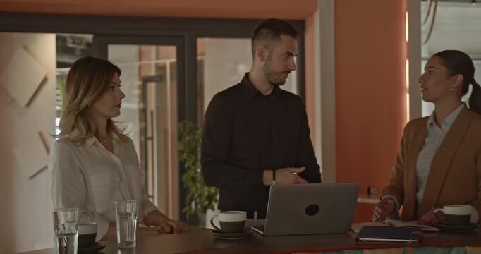 Business partners in a modern office space celebrate a significant achievement for their growing small business. Their collaboration and teamwork have led to remarkable success and joy.