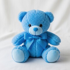 Blue fluffy teddy bear with a bow sitting on a white backdrop studio