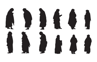 Silhouette of an old woman warming herself in the winter