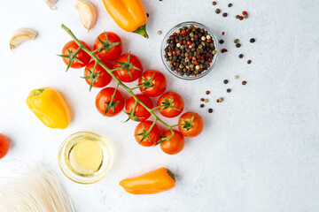 fresh tomatoes peppercorns oil salt and peppers on white background