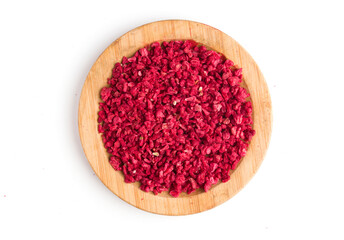 dried raspberries in pieces on a wooden plate. Top view