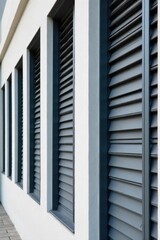 Obraz premium Modern Architectural Shutters in a Sleek Urban Setting, Representing Contemporary Design and Clean Lines A precisely composed image of matte grey metal architectural shutters on a contemporary urban