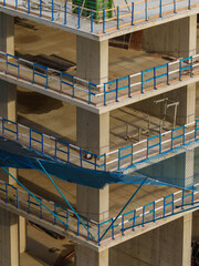 Multi-Story Concrete Building Under Construction with Safety Railings