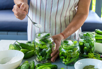Preserving cucumbers in jars. Selective focus.