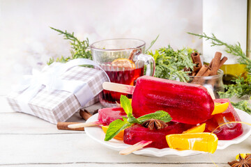 Tasty winter mulled wine ice cream popsicles. Frozen mulled wine cocktail on sticks, traditional winter and Christmas drink in party dessert form