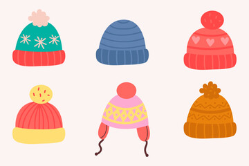Winter knitted hats set with pom poms and festive patterns