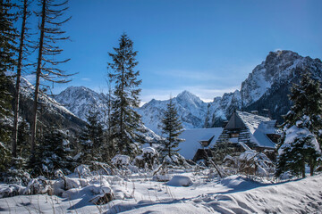 a picturesque mountain hut covered in snow