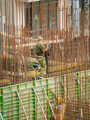 Team of Builders Working with Rebar and Formwork on Site