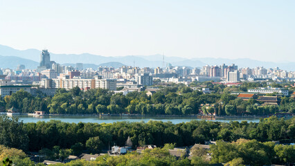 Scenic view of city with river and greenery in foreground