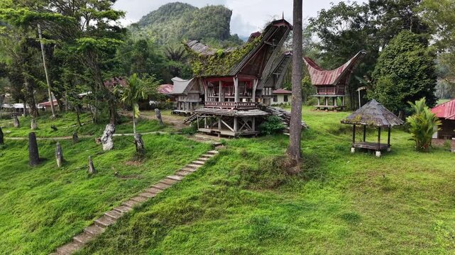 Aerial view of the traditional Tongkonan houses in Ke&rsquo;te Kesu village, Tana Toraja, Indonesia, surrounded by lush green rice fields.	