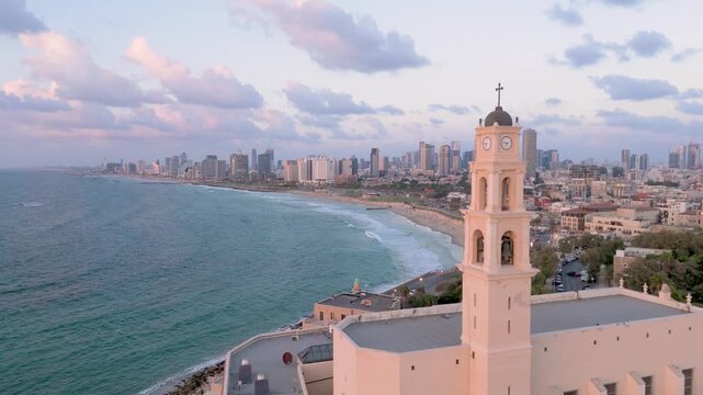 Aerial view of the stunning Tel Aviv-Yafo skyline meeting the tranquil turquoise sea, with Old Jaffa buildings and a sandy beach below, Tel Aviv-Yafo, Israel.