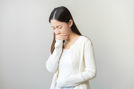 Unhappy pregnant asian young woman, pain girl suffering from nausea, having vomit feeling sick covering mouth, touching belly having problem throwing up from food poisoning, lady with morning sickness