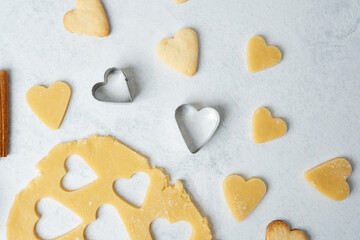 Heart shaped cookies with cinnamon and raw dough for baking or valentines day concept