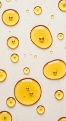 Golden liquid droplets on a light beige surface