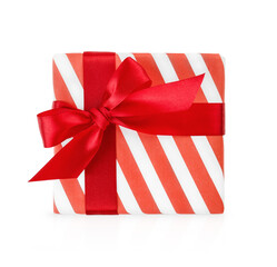 Christmas gift box wrapped in paper and decorated with red ribbon and bow isolated on white background with clipping path. Christmas, Valentines Day or Birthday celebration themes. Design element.