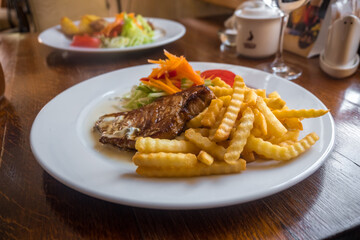 Grilled Pork Chops with Potato and Salad. Lithuanian Cuisine and Food.
