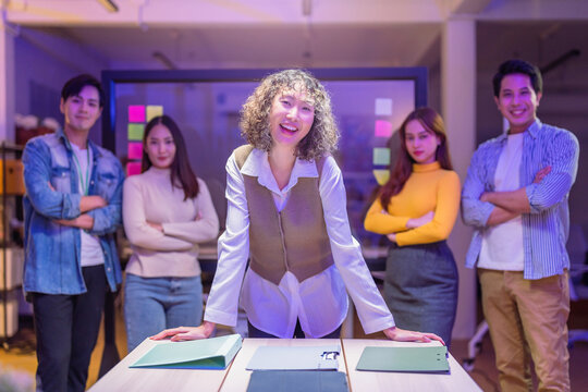 dynamic team of smart new generation professionals, including confident men and women, collaborate late at night in a modern office for an AI-driven startup brainstorming session