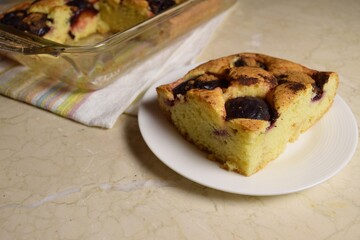 A slice of homemade plum pie with cinnamon