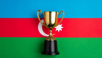 Gold trophy placed in front of Azerbaijan flag