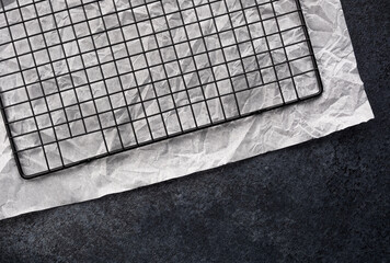 Baking rack resting on crumpled parchment paper in a kitchen setting