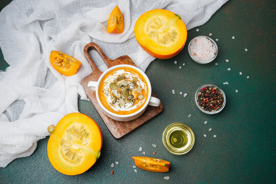 Warm pumpkin soup with cream and seeds, served with fresh pumpkin and spices - Powered by Adobe