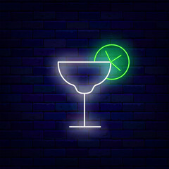 Cocktail with lime slice neon icon. Drinking glass at bar. Tequila and Sour flavor. Vector stock illustration