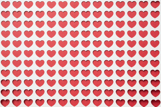 Background of multiple red hearts framed by white.  Love, valentine's day background or template.