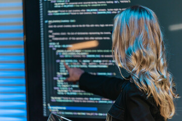 Female Software Engineer Presenting Code During Technical Meeting