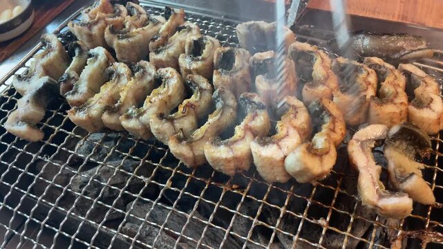 Grilled eel on charcoal fire &ndash; Korean BBQ cooking with smoke and sizzling seafood 4K
