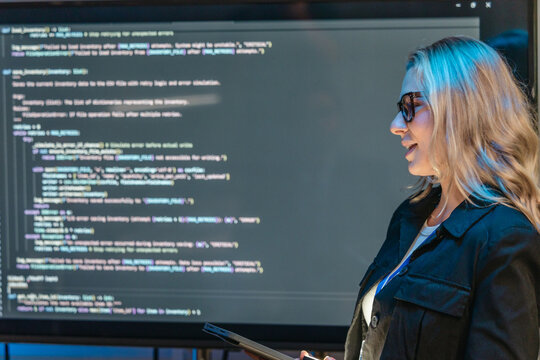 Female Software Engineer Presenting Code During Technical Meeting